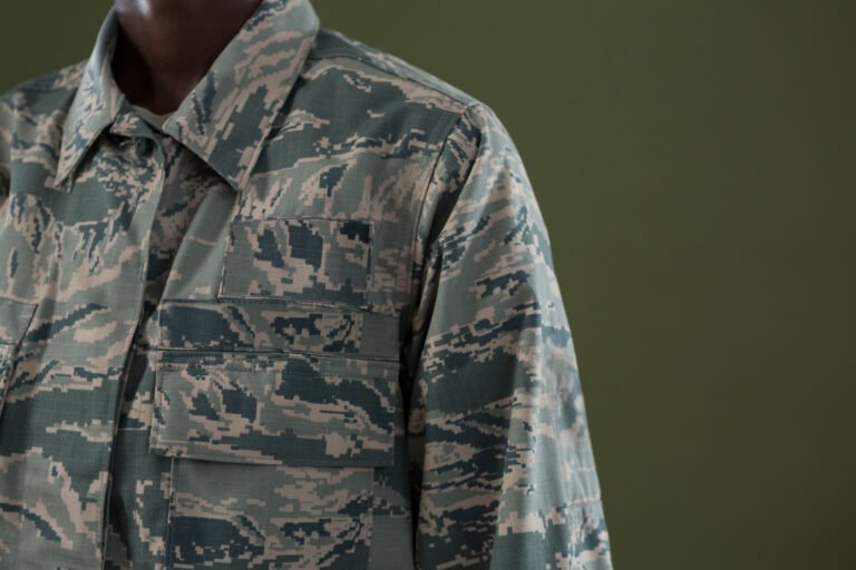 Mid-section of androgynous man in camouflage uniform